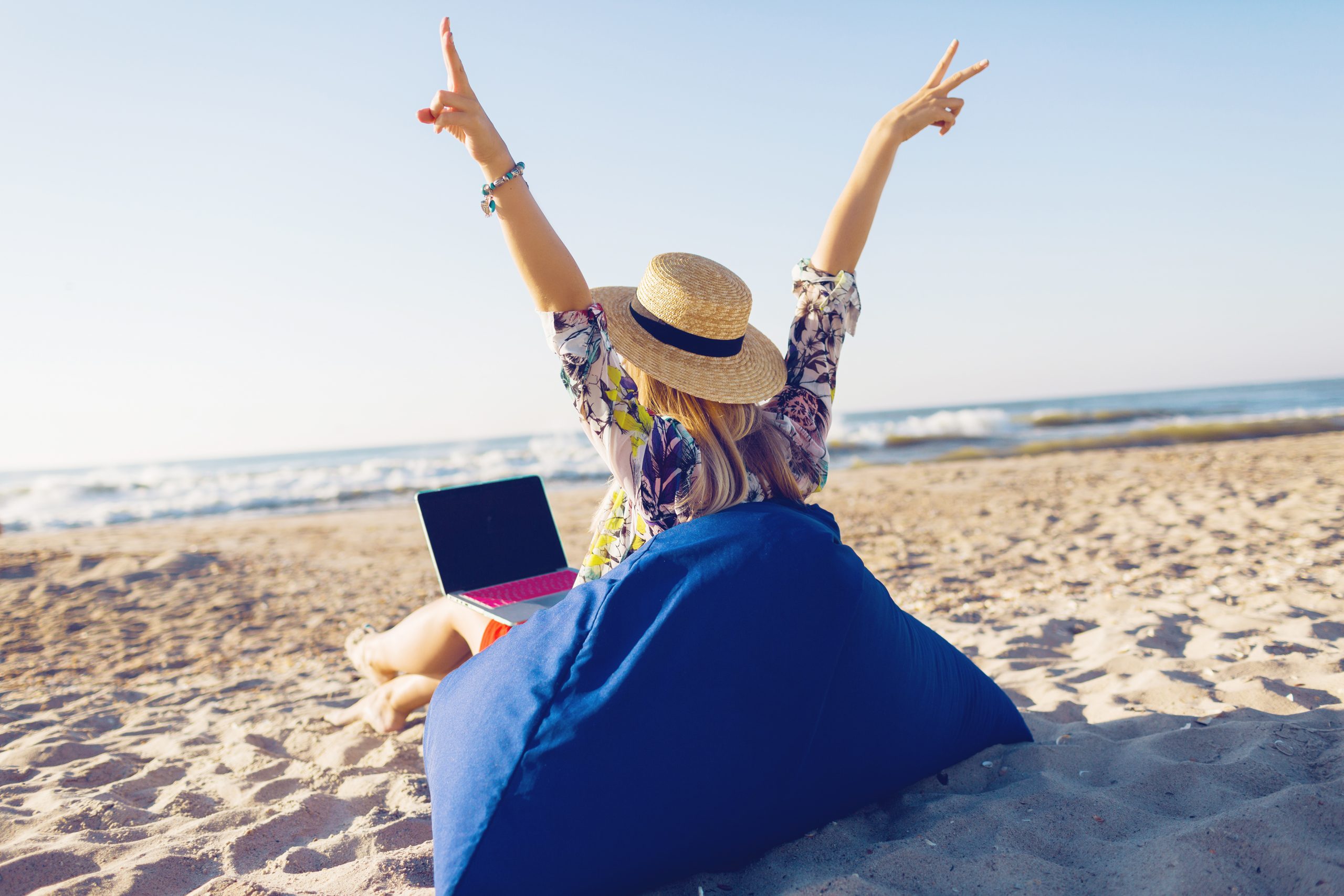 beautiful young woman working with laptop tropical beach scaled